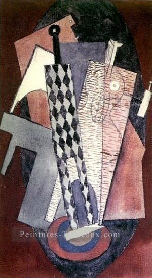 Arlequin locataire une bouteille et femme 1915 Cubisme Peintures à l'huile